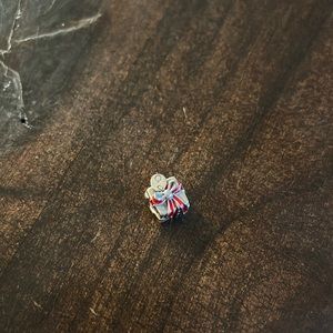 Pandora charm- gift box with red ribbon and dangling tag.